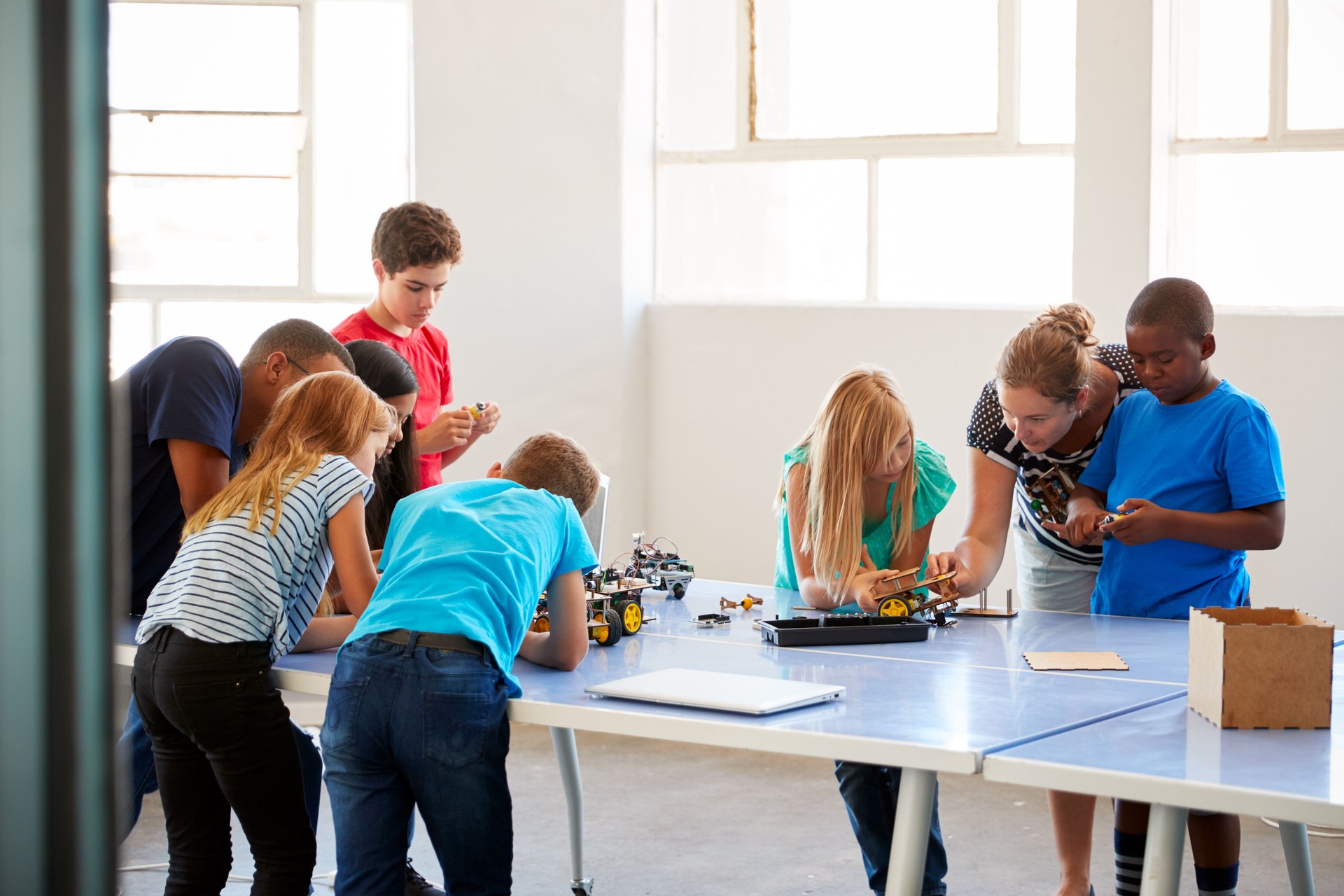 Students In After School Computer Coding Class Building And Learning To Program Robot Vehicle
