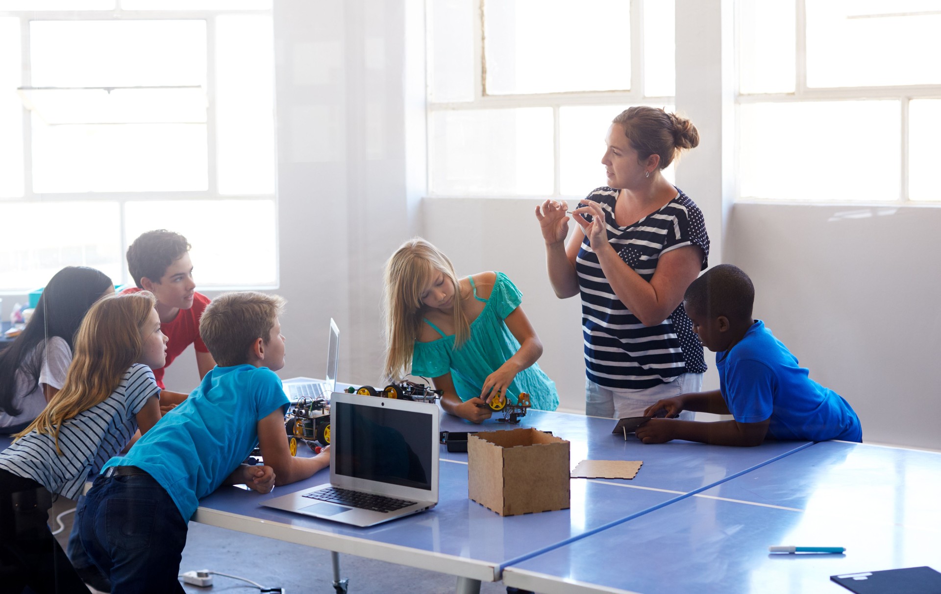 Students In After School Computer Coding Class Building And Learning To Program Robot Vehicle