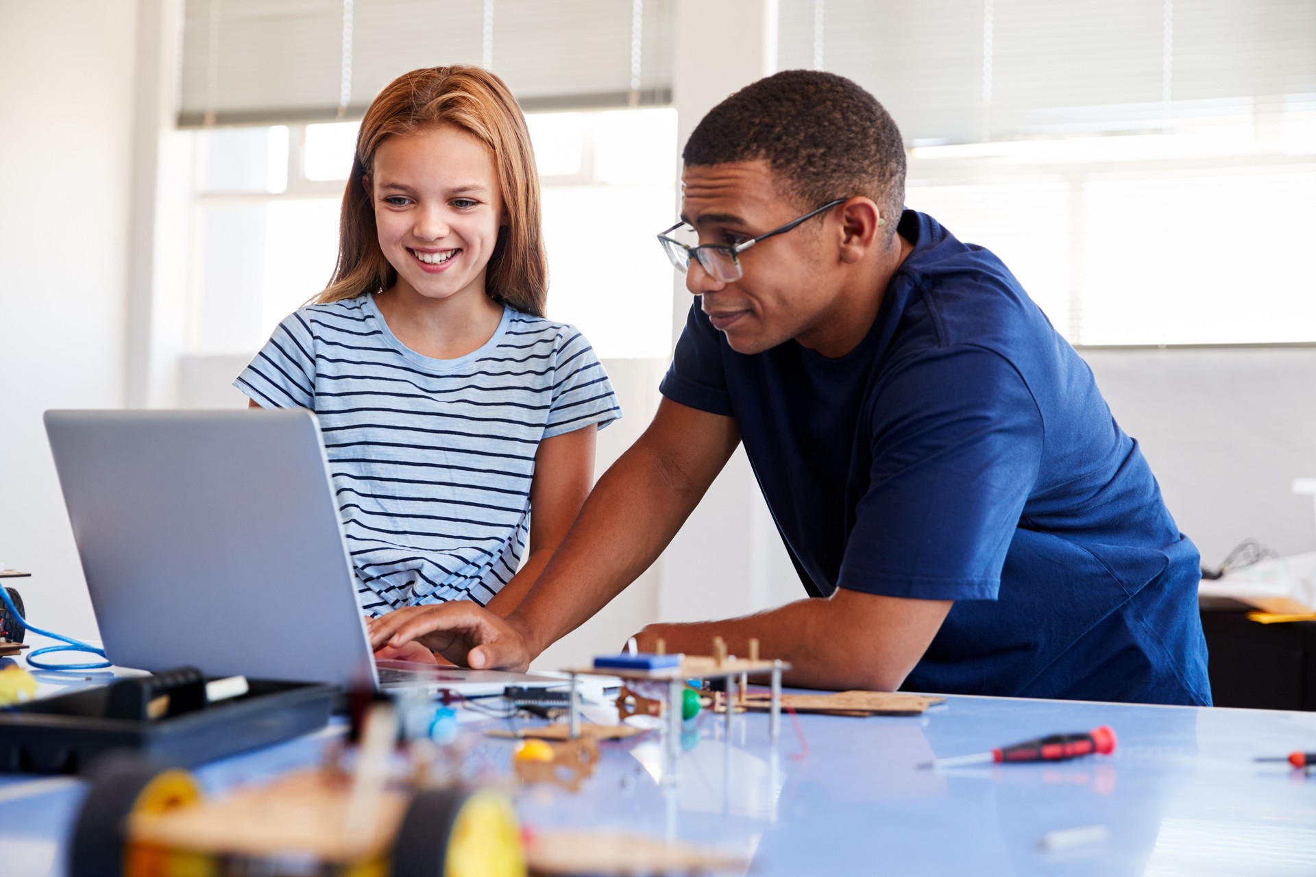 Female Student With Teacher Building Robot Vehicle In After School Computer Coding Class
